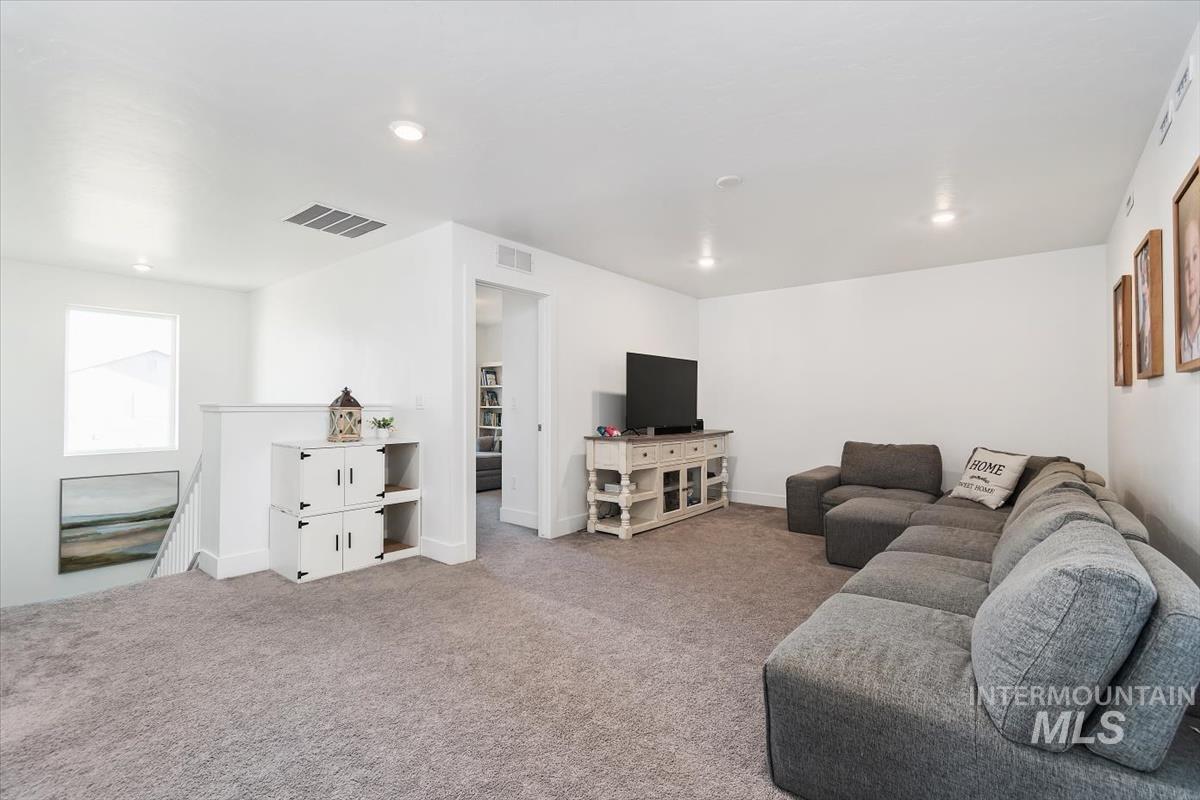 14361 Fractus Drive Caldwell, ID 83607 - Photo 28 of 50 Upstairs- Carpeted living room with recessed lighting and baseboards