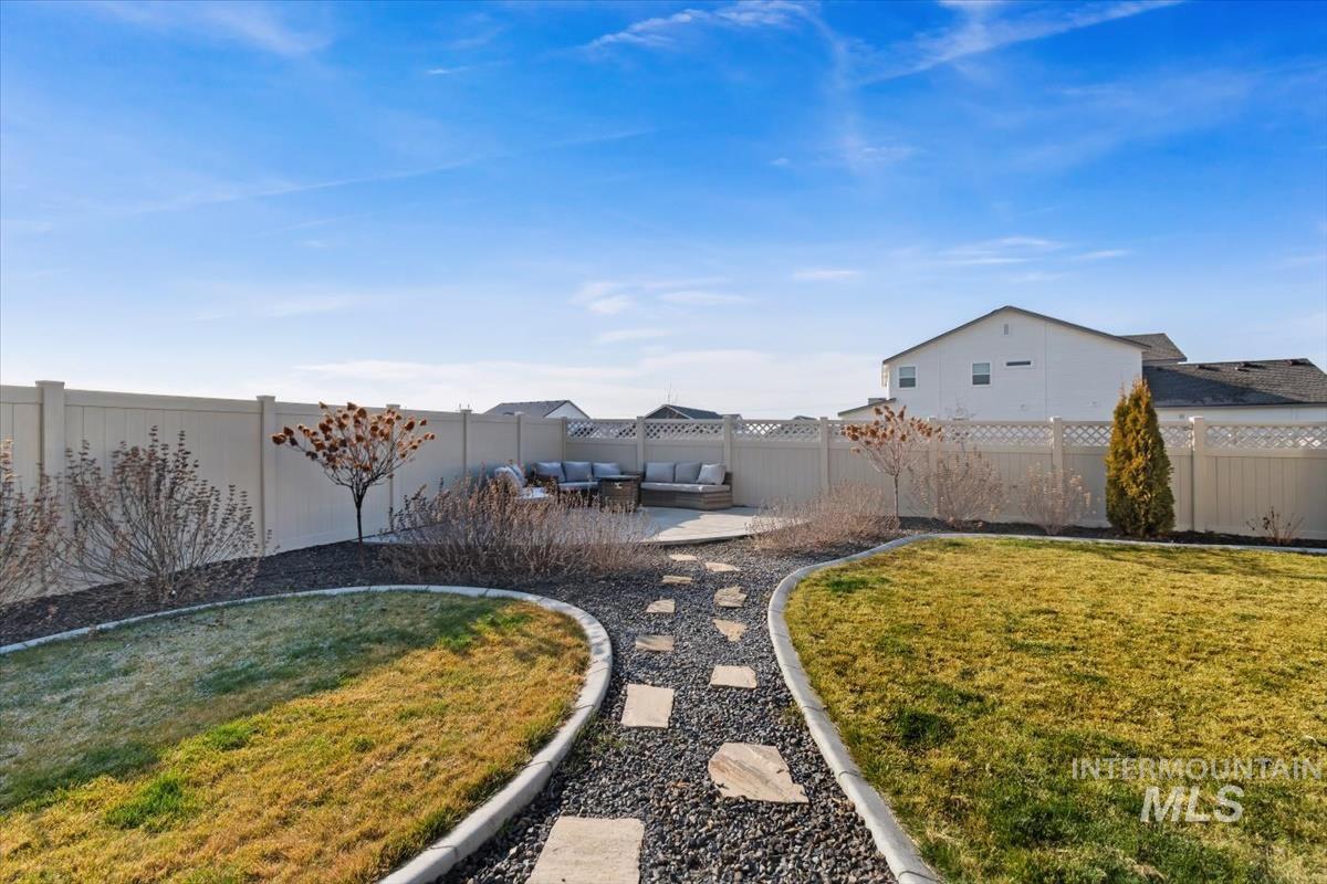 14361 Fractus Drive Caldwell, ID 83607 - Photo 31 of 50 Fenced backyard featuring a patio area and an outdoor hangout area