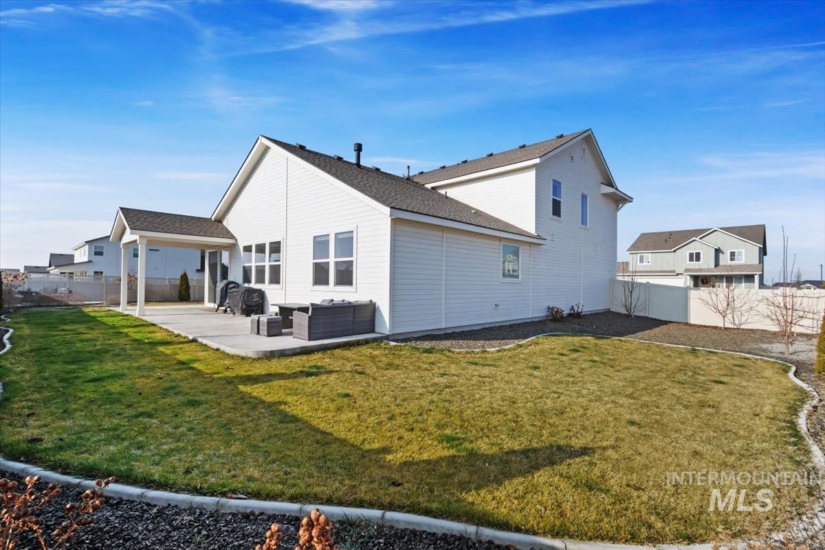 14361 Fractus Drive Caldwell, ID 83607 - Photo 33 of 50 Back of property featuring a fenced backyard, a patio, and outdoor lounge area
