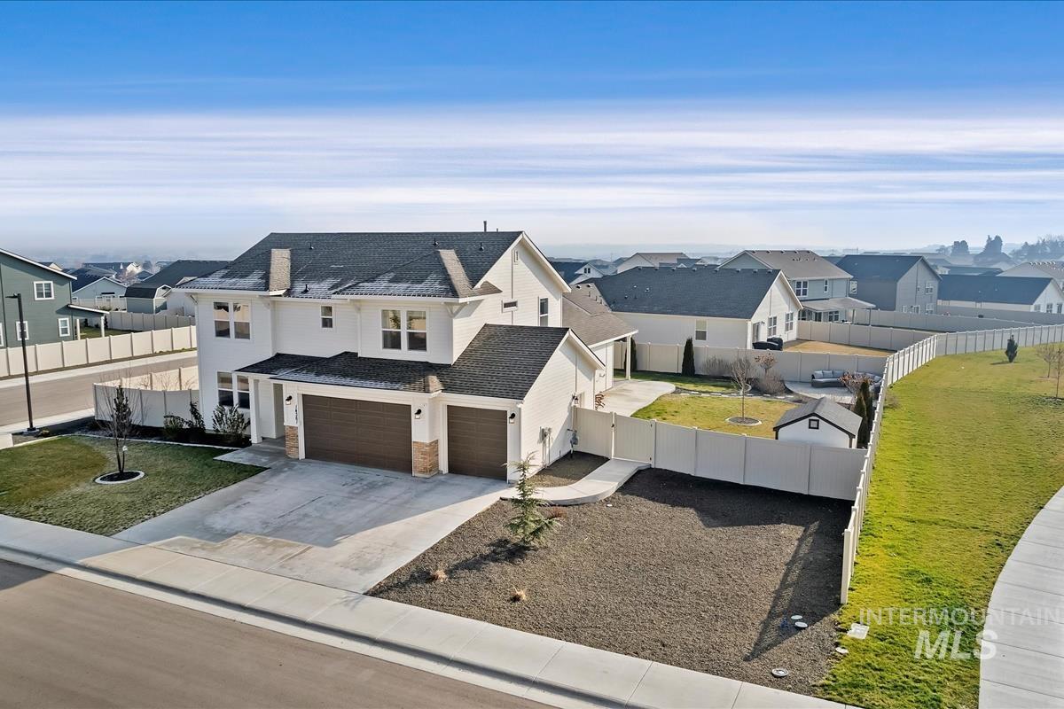 14361 Fractus Drive Caldwell, ID 83607 - Photo 36 of 50 View of front of house featuring a residential view, concrete driveway, a fenced backyard, and an attached garage
