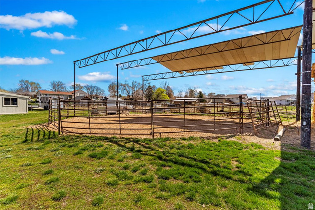 5321 South 3100th Street West Roy, UT 84067 - Photo 14 of 64 Outdoor arena with a metal frame shade structure, perimeter fencing, and a sand base