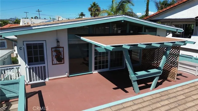 a roof deck with table and chairs