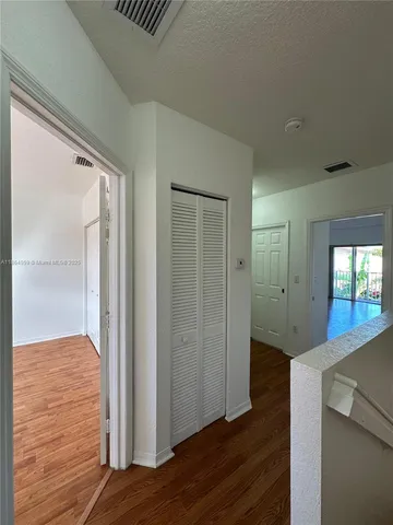 a view of hallway with wooden floor
