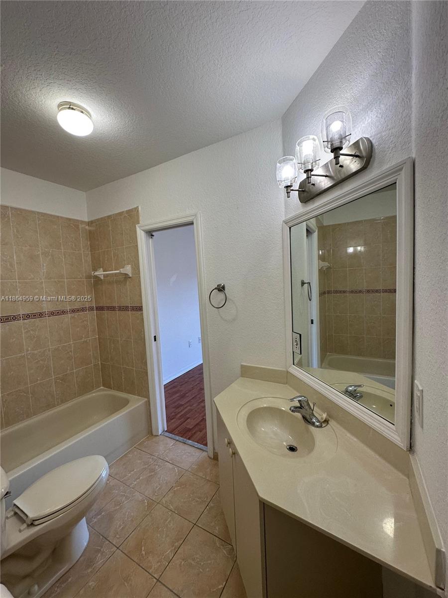 13713 Southwest 171st Lane Miami, FL 33177 - Photo 15 of 18 a bathroom with a sink a toilet and shower