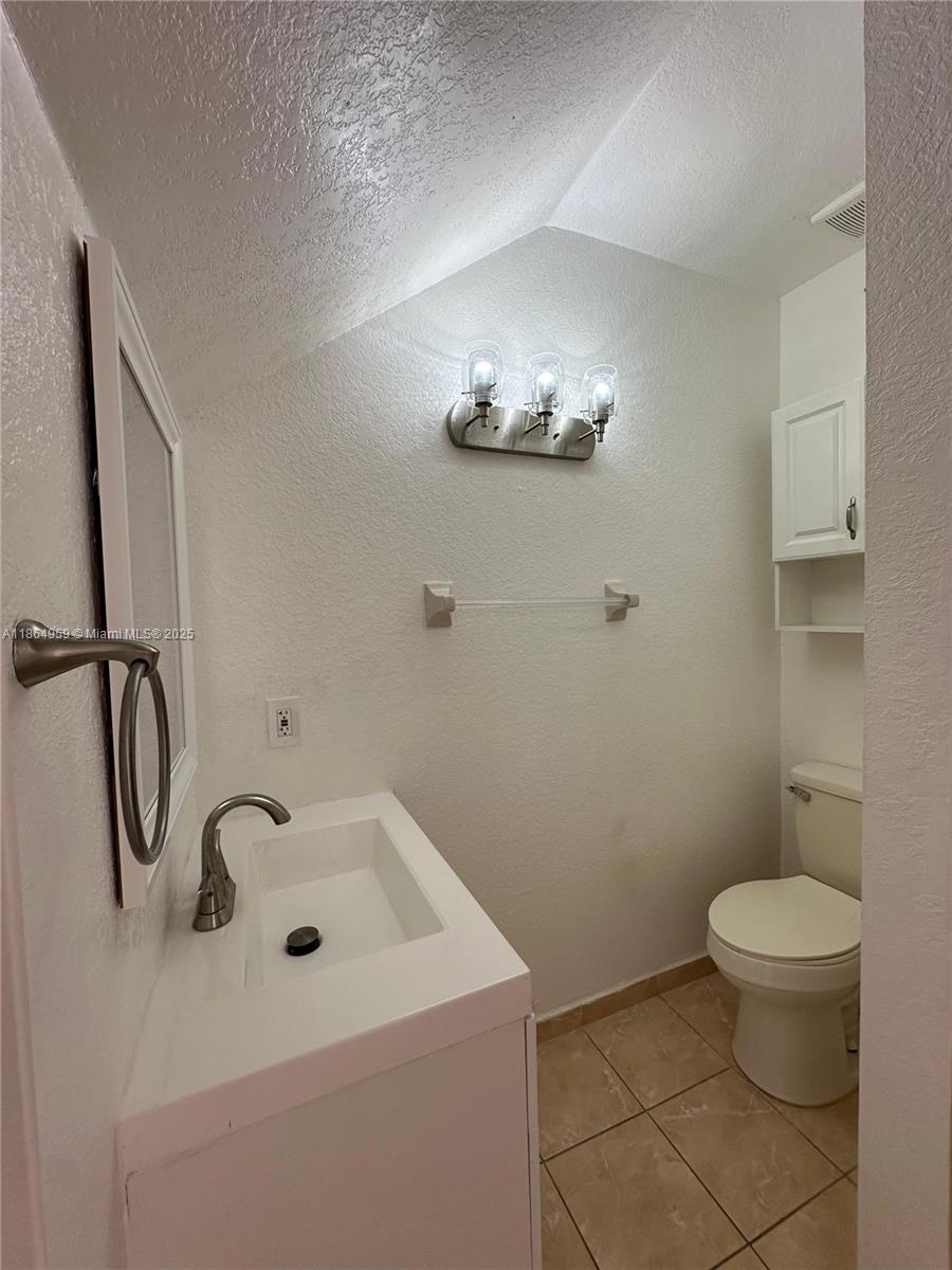 13713 Southwest 171st Lane Miami, FL 33177 - Photo 4 of 18 a bathroom with a sink toilet and shower