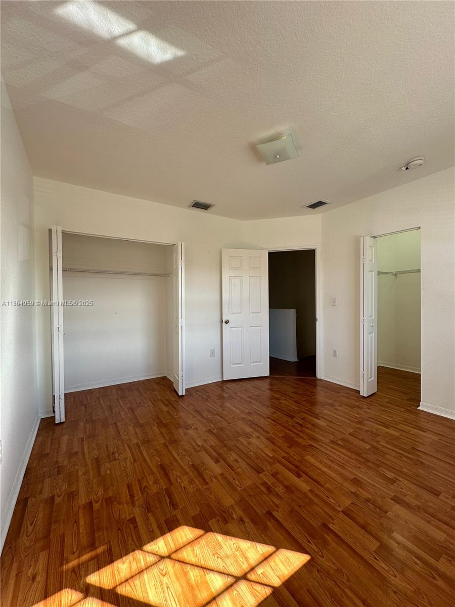 13713 Southwest 171st Lane Miami, FL 33177 - Photo 9 of 18 a view of empty room with wooden floor