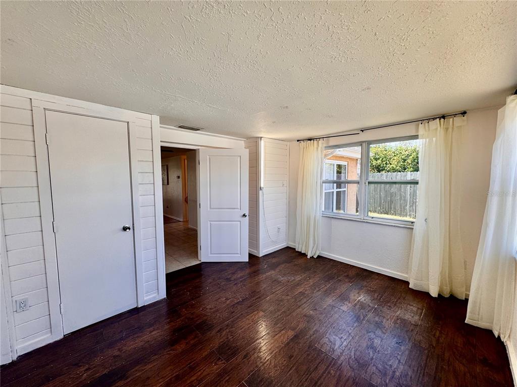 3902 Glissade Drive New Port Richey, FL 34652 - Photo 15 of 26 an empty room with wooden floor windows and cabinet