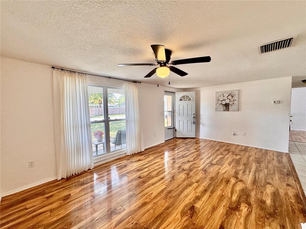 3902 Glissade Drive New Port Richey, FL 34652 - Photo 6 of 26 a view of a livingroom with a ceiling fan and window