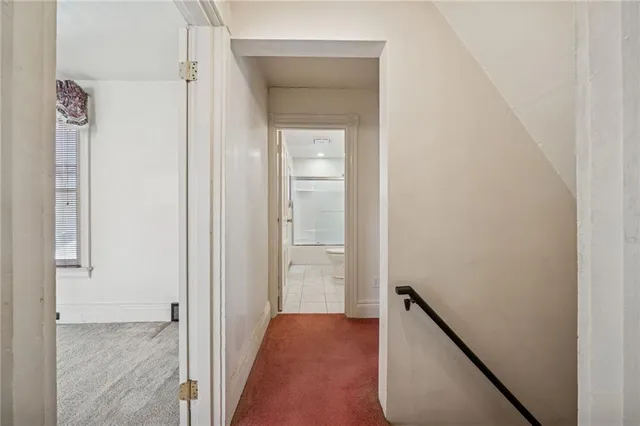 a view of a hallway with wooden floor and closet