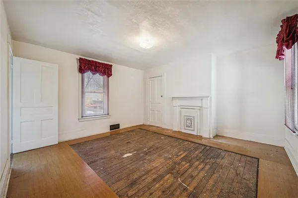 a bed room with a bed and a painting on the wall