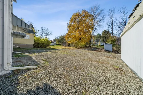 a view of a yard with wooden fence