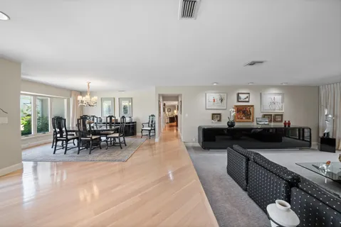 a living room with furniture and a dining table with kitchen view
