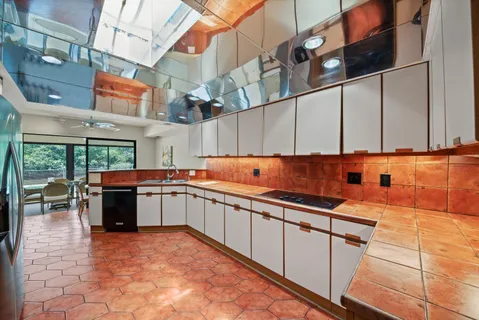 a kitchen with stainless steel appliances granite countertop a sink and cabinets