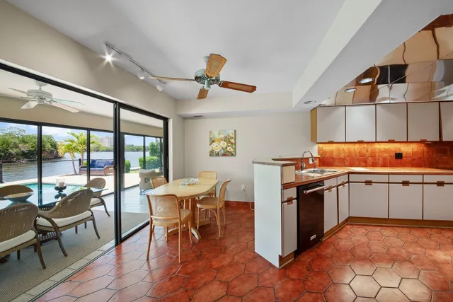 a kitchen with a stove a table and chairs in it