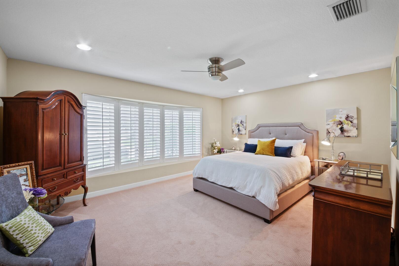 7 Inlet Cay Drive Ocean Ridge, FL 33435 - Photo 22 of 54 a spacious bedroom with a bed and a flat screen television