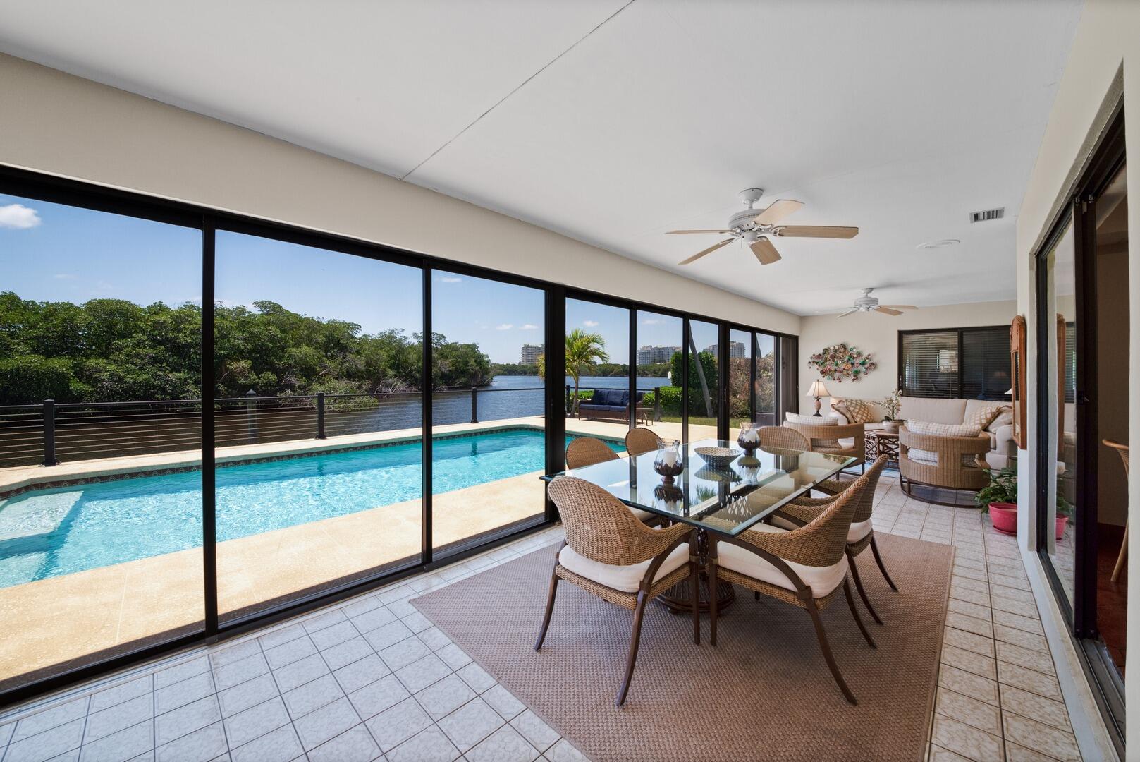 7 Inlet Cay Drive Ocean Ridge, FL 33435 - Photo 29 of 54 a dining room with furniture water view and a floor to ceiling window