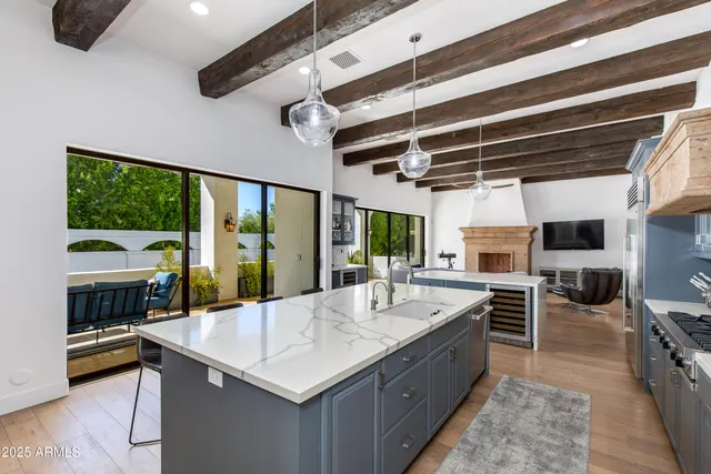 a large kitchen with kitchen island a large window in it