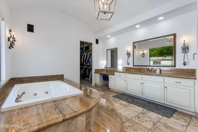 a bathroom with a tub sink and mirror