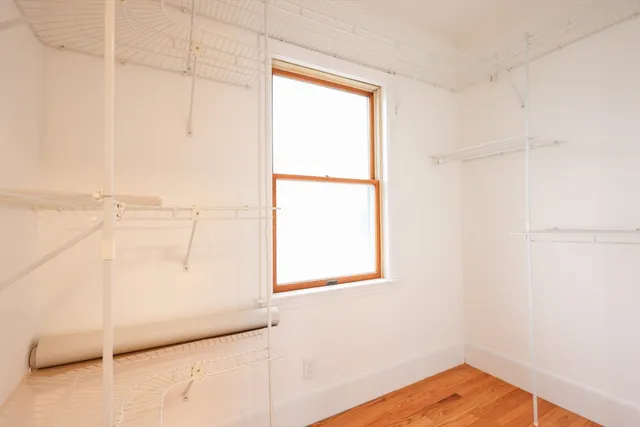 a view of a room with wooden floor