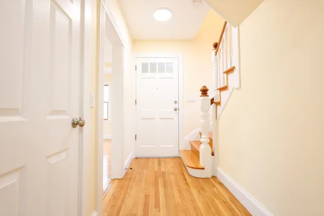 a view of a room with wooden floor and white walls