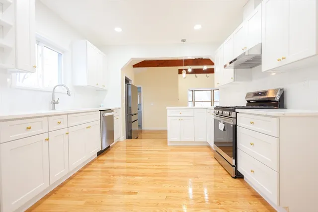 a kitchen with cabinets oven and white appliances