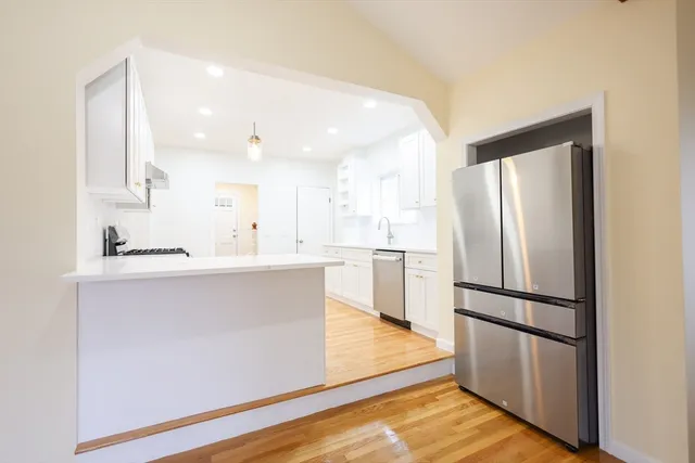 a kitchen with stainless steel appliances a refrigerator sink and cabinets