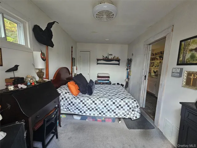 a bedroom with a bed and window