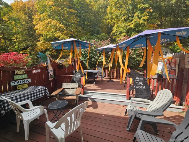 a view of a patio with a table and chairs under an umbrella