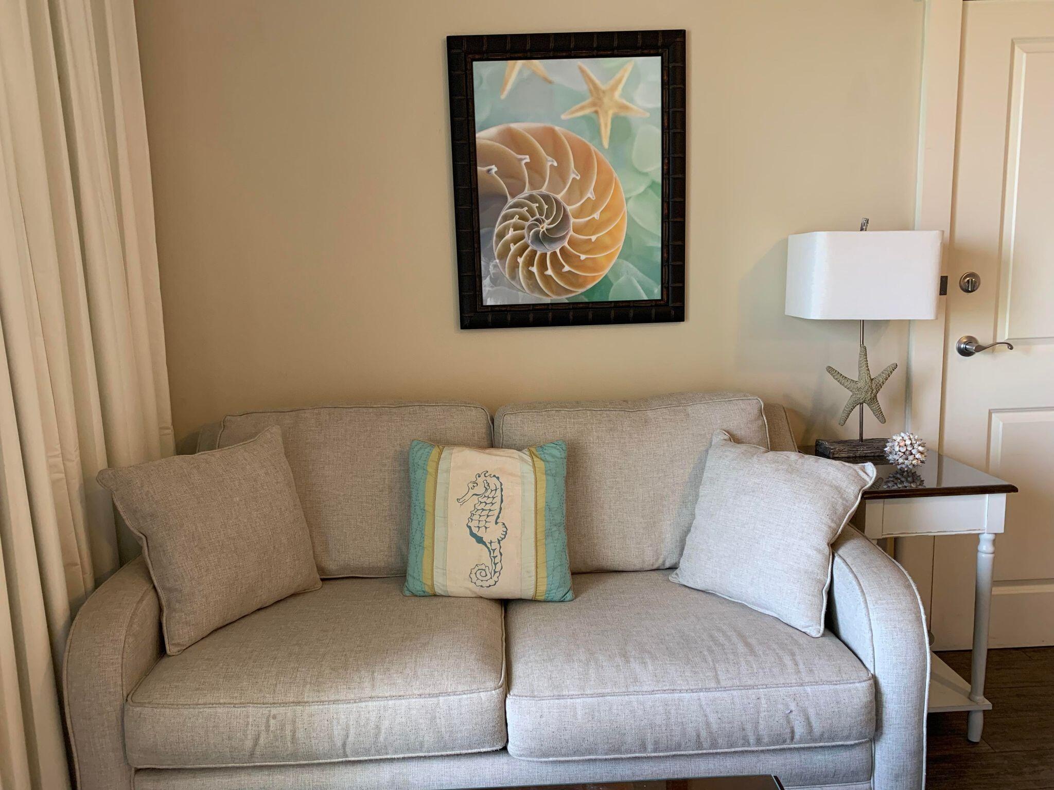 15100 Front Beach Road, Unit 919 921 Panama City Beach, FL 32413 - Photo 11 of 49 a living room with a couch and a table