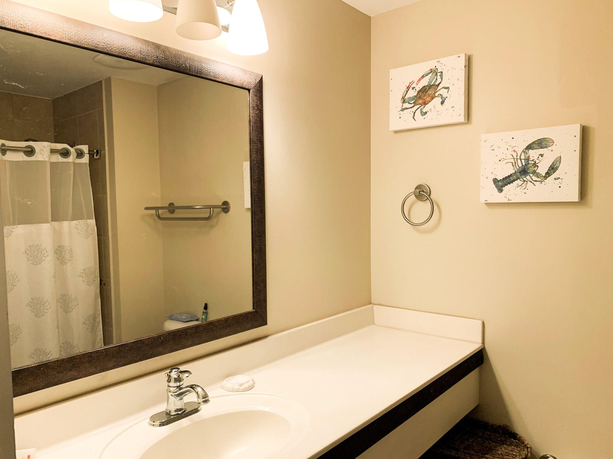 15100 Front Beach Road, Unit 919 921 Panama City Beach, FL 32413 - Photo 13 of 49 a bathroom with a sink and a mirror