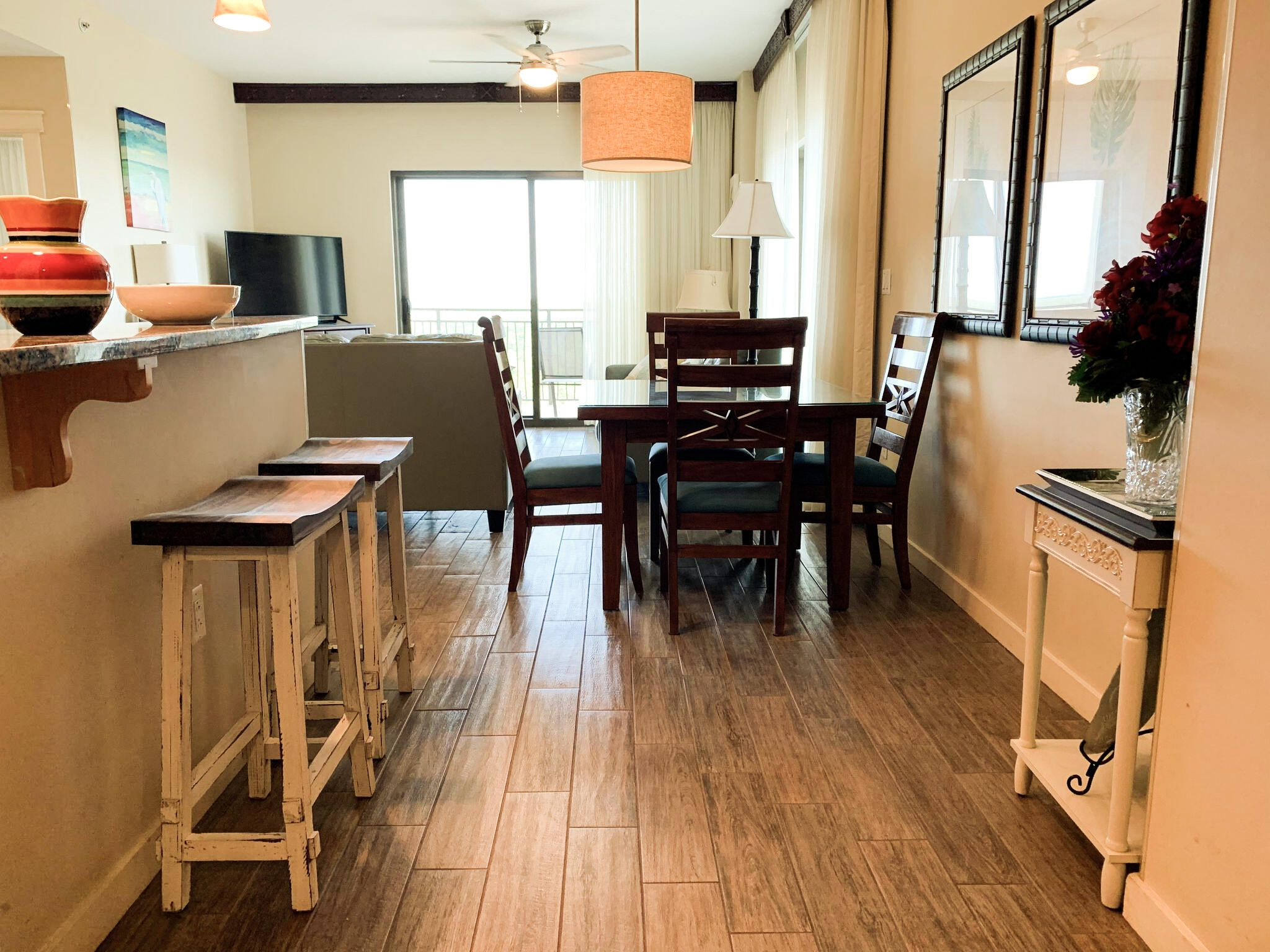 15100 Front Beach Road, Unit 919 921 Panama City Beach, FL 32413 - Photo 19 of 49 a view of a dining room with furniture window and wooden floor