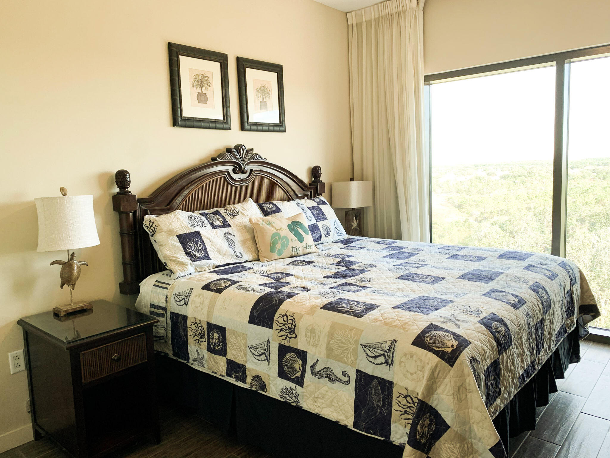 15100 Front Beach Road, Unit 919 921 Panama City Beach, FL 32413 - Photo 25 of 49 a bedroom with a bed and wooden floor