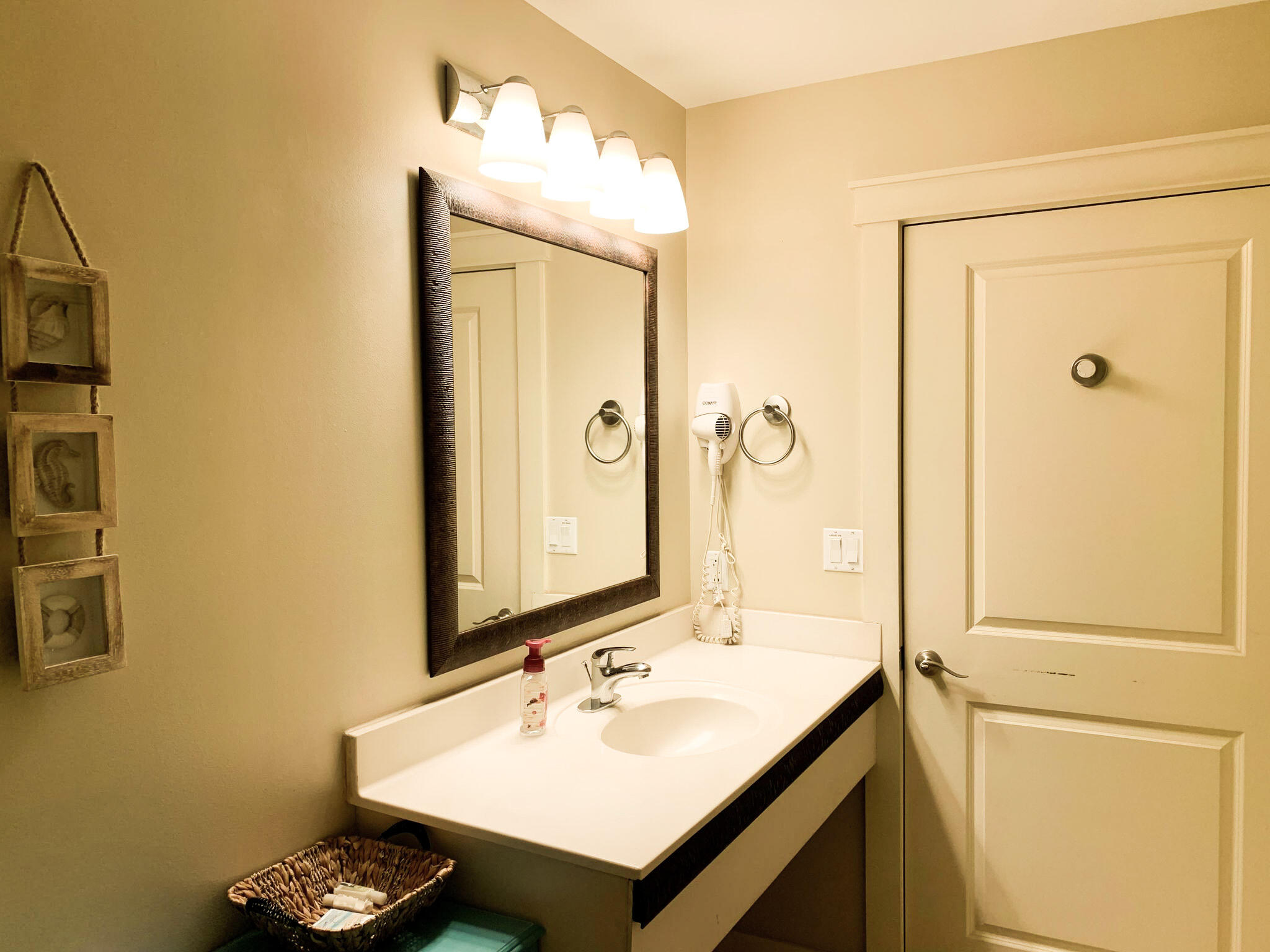 15100 Front Beach Road, Unit 919 921 Panama City Beach, FL 32413 - Photo 33 of 49 a bathroom with a sink and a mirror