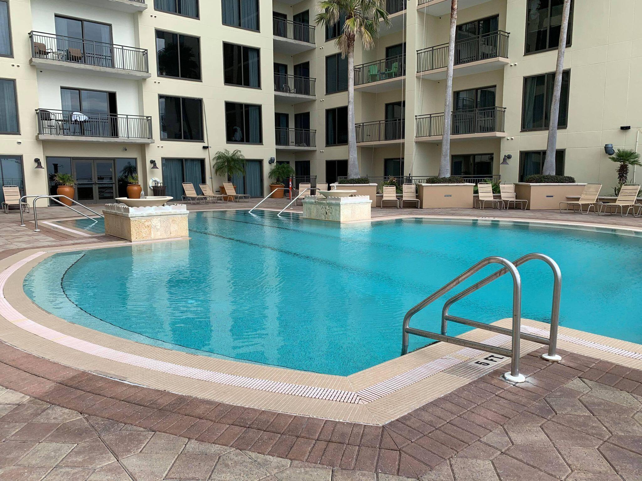 15100 Front Beach Road, Unit 919 921 Panama City Beach, FL 32413 - Photo 38 of 49 a view of a swimming pool with a lounge chairs