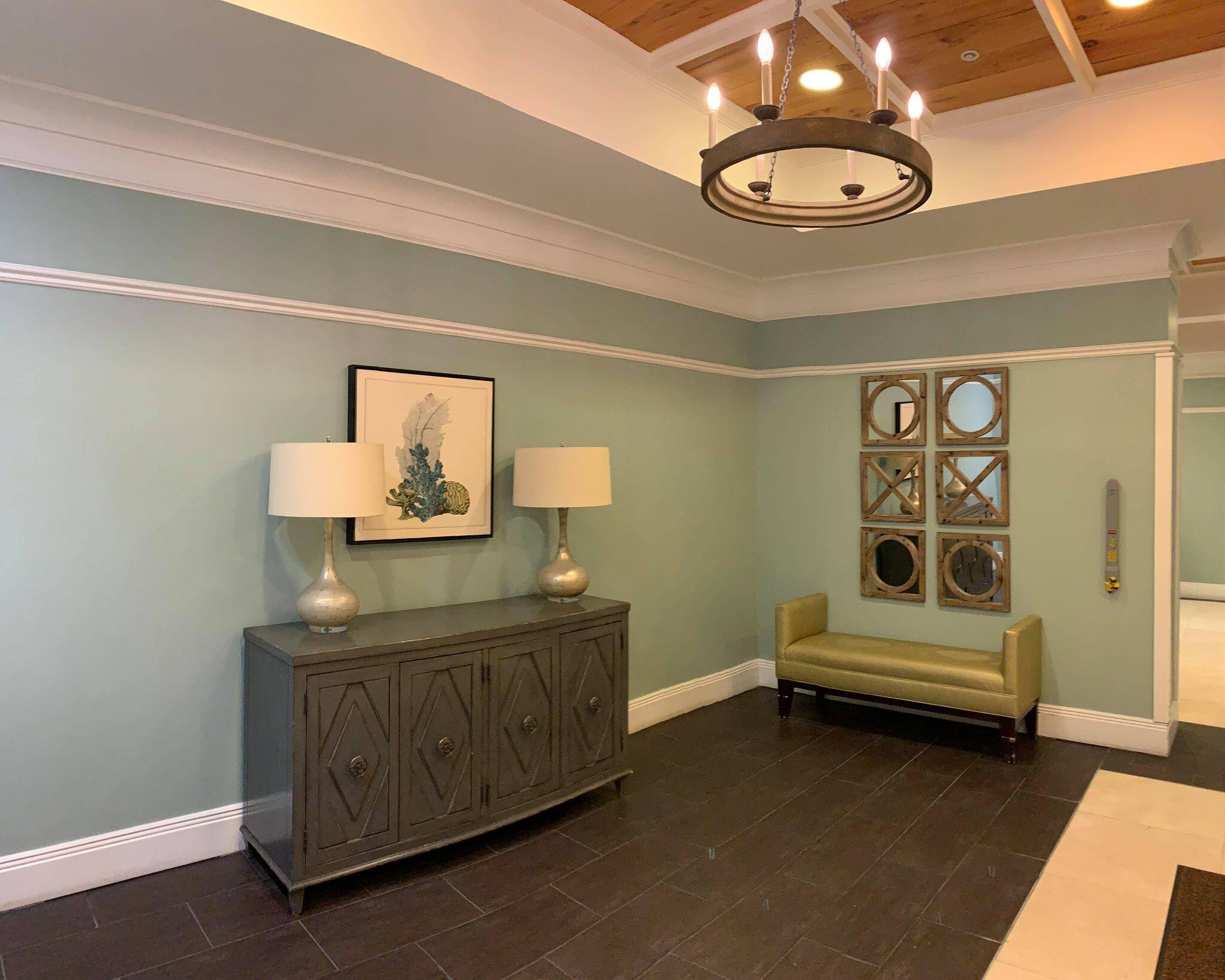 15100 Front Beach Road, Unit 919 921 Panama City Beach, FL 32413 - Photo 39 of 49 a spacious bedroom with a bed and a chandelier