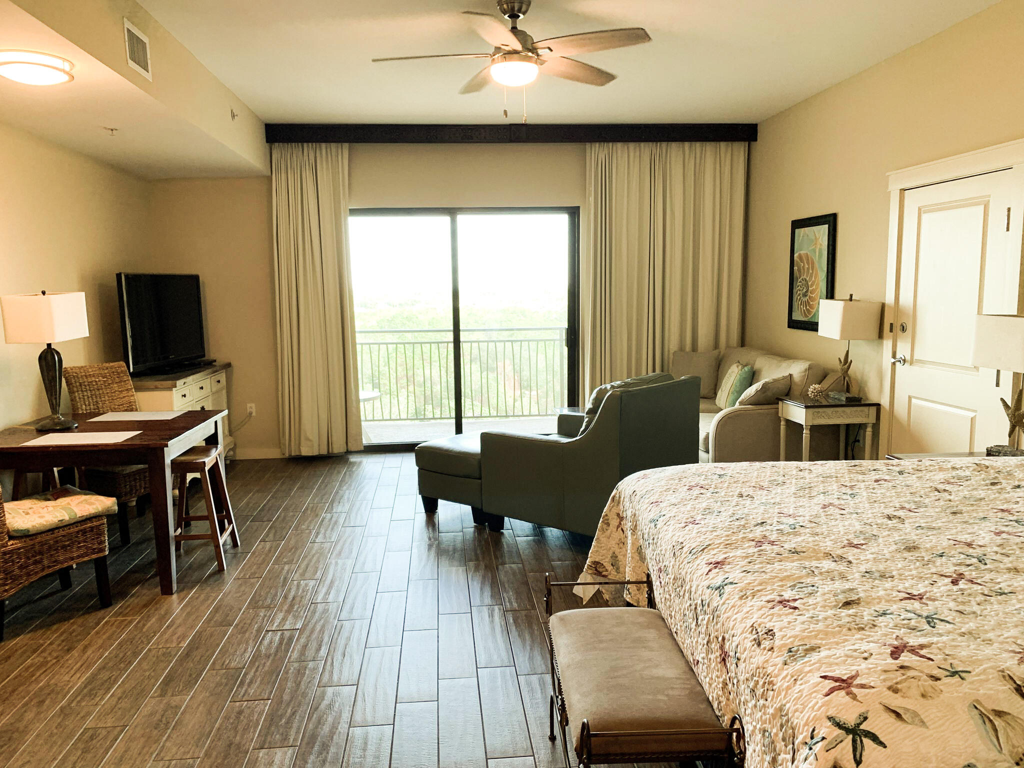 15100 Front Beach Road, Unit 919 921 Panama City Beach, FL 32413 - Photo 4 of 49 a living room with furniture and a flat screen tv