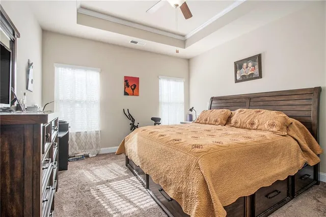 a bedroom with a bed and a flat tv screen