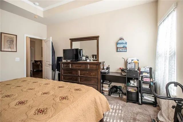 a bedroom with a bed and a desk