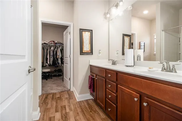 a bathroom with a sink a mirror and a shower