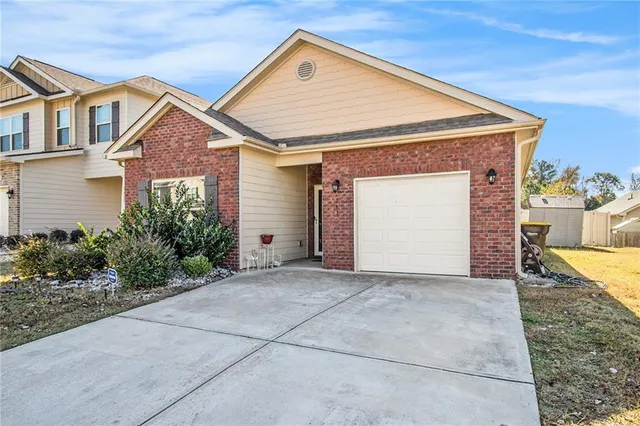 a view of a house with a yard and garage