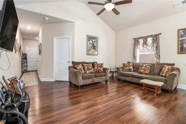 a living room with furniture and a wooden floor