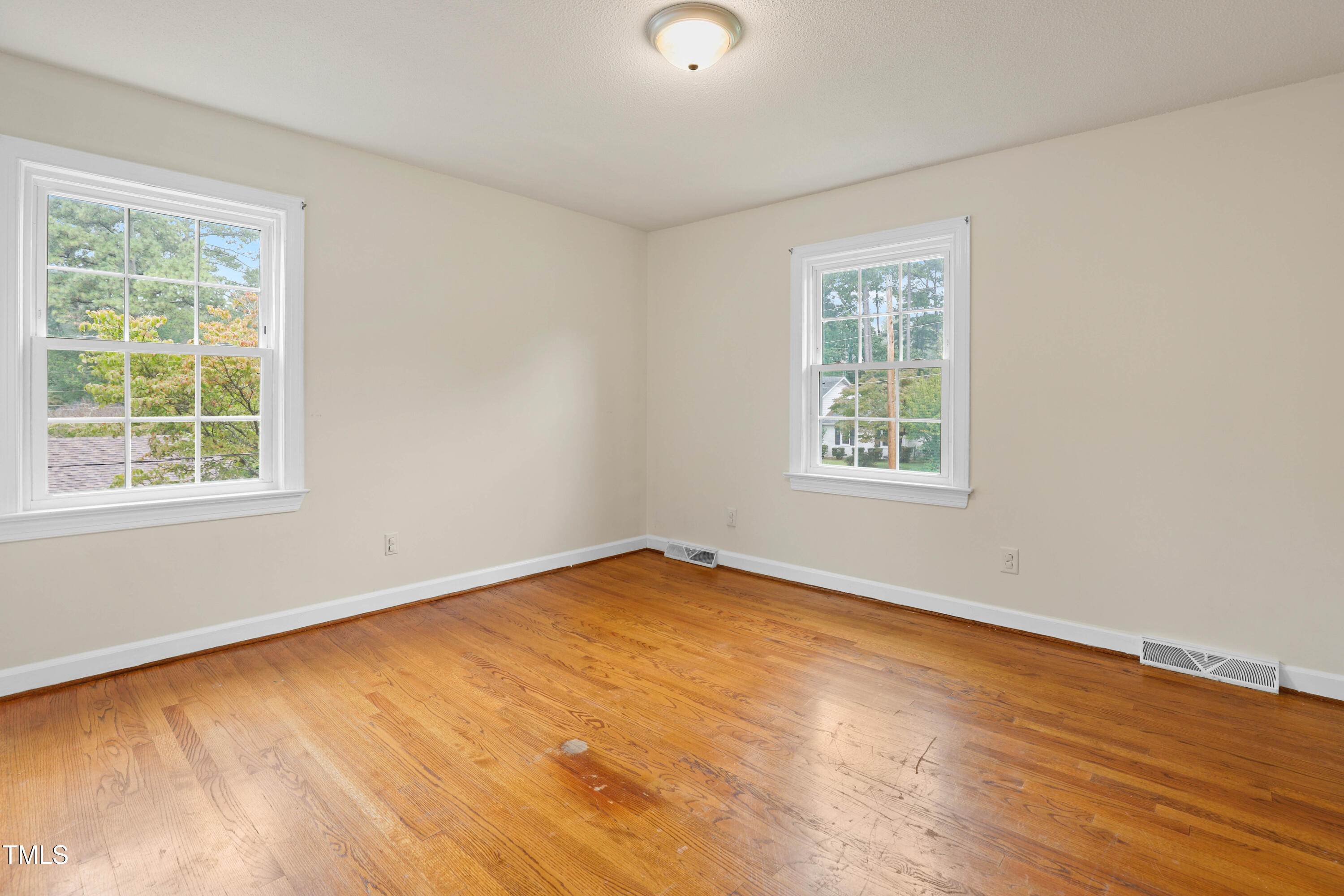 1204 Country Ridge Drive Raleigh, NC 27609 - Photo 15 of 49 wooden floor in an empty room with a window