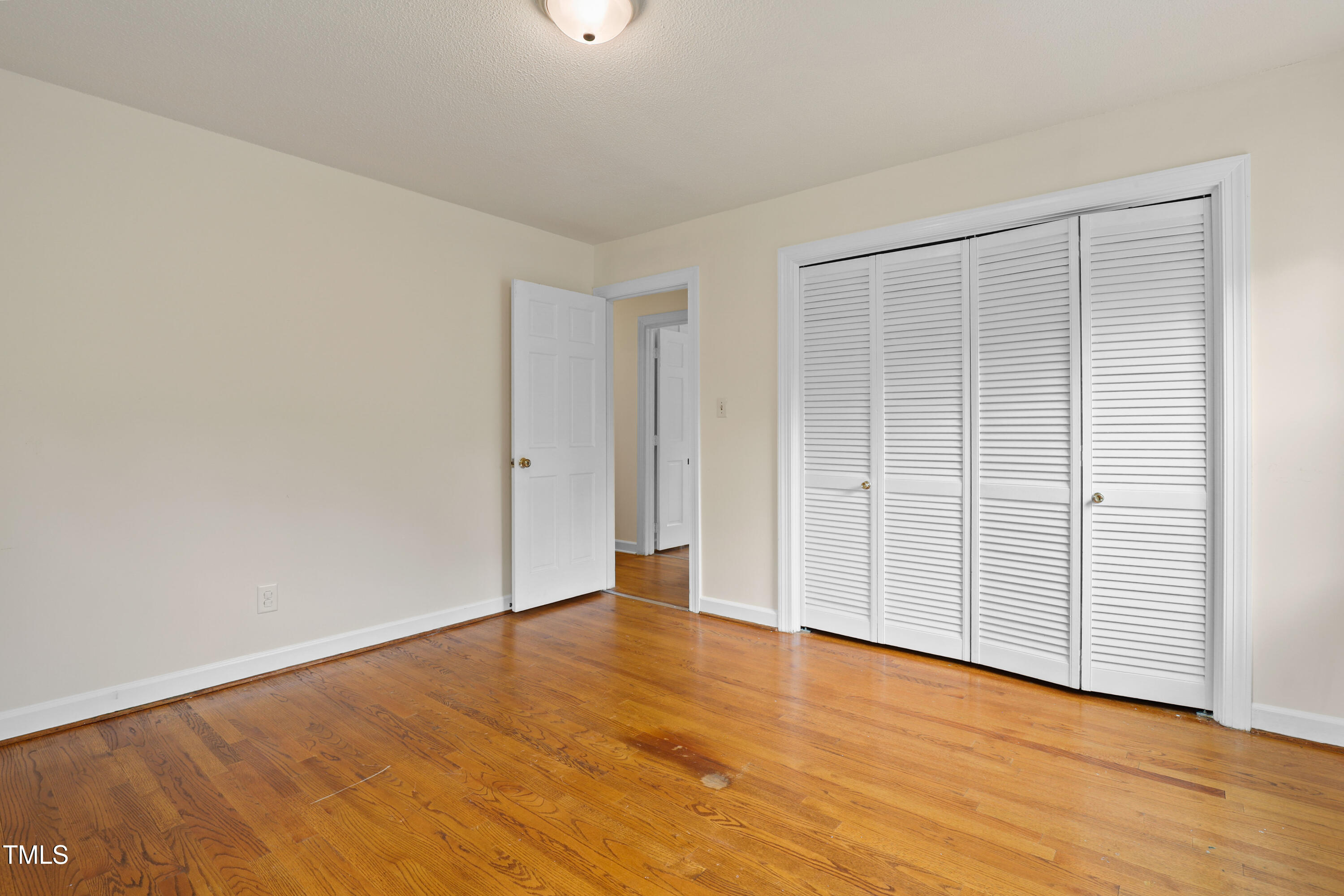 1204 Country Ridge Drive Raleigh, NC 27609 - Photo 16 of 49 an empty room with wooden floor