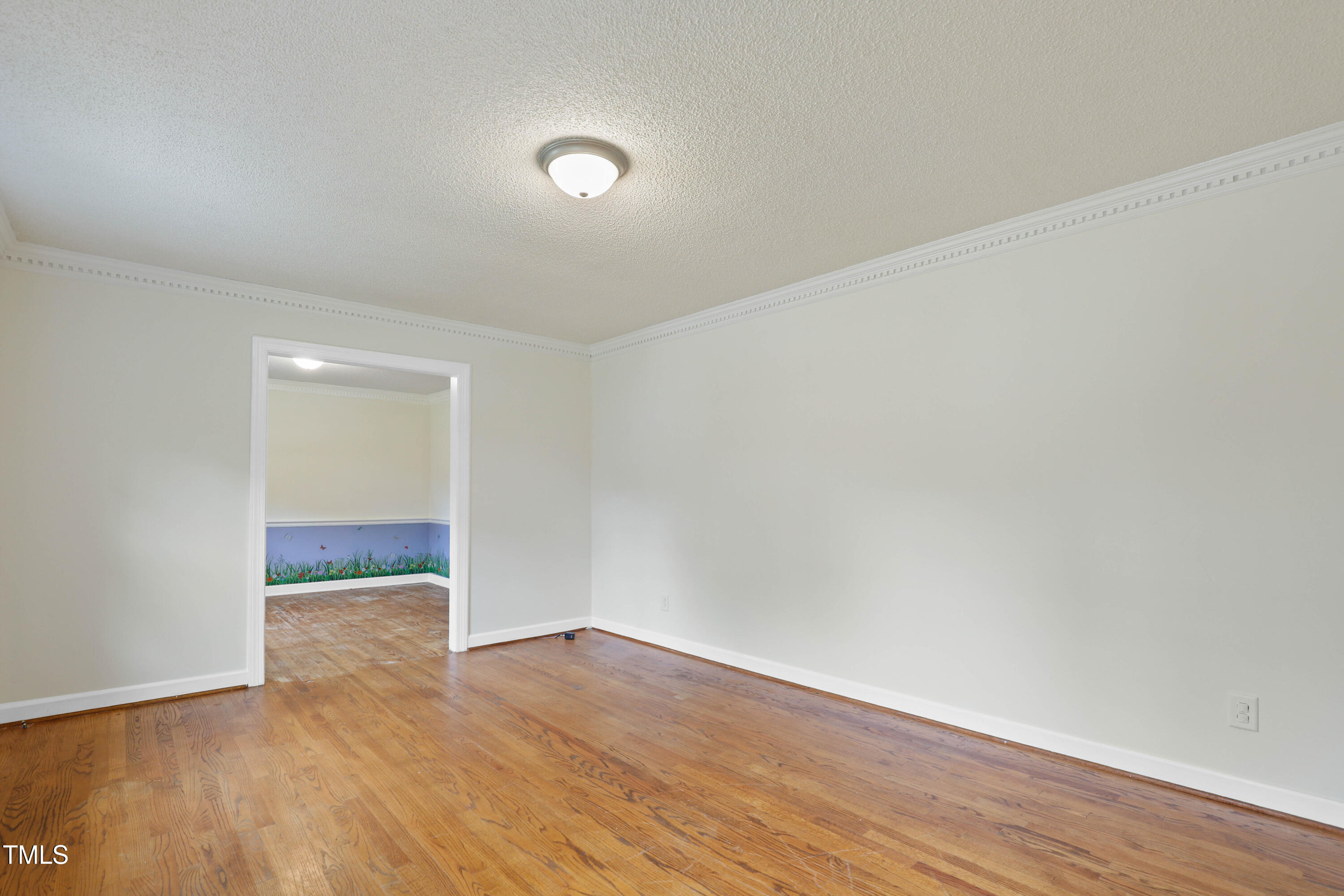 1204 Country Ridge Drive Raleigh, NC 27609 - Photo 17 of 49 a view of an empty room with wooden floor