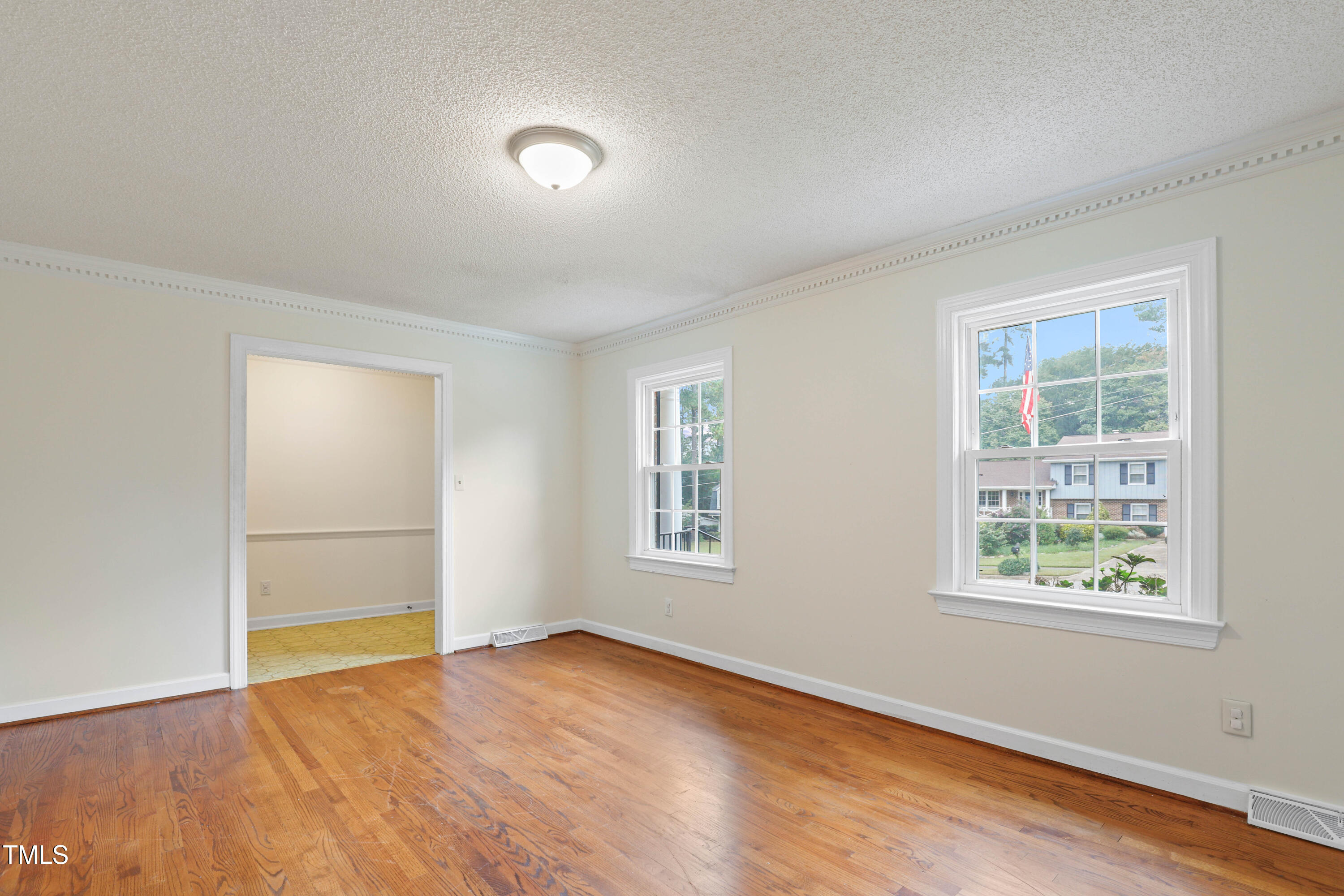1204 Country Ridge Drive Raleigh, NC 27609 - Photo 18 of 49 an empty room with wooden floor and windows