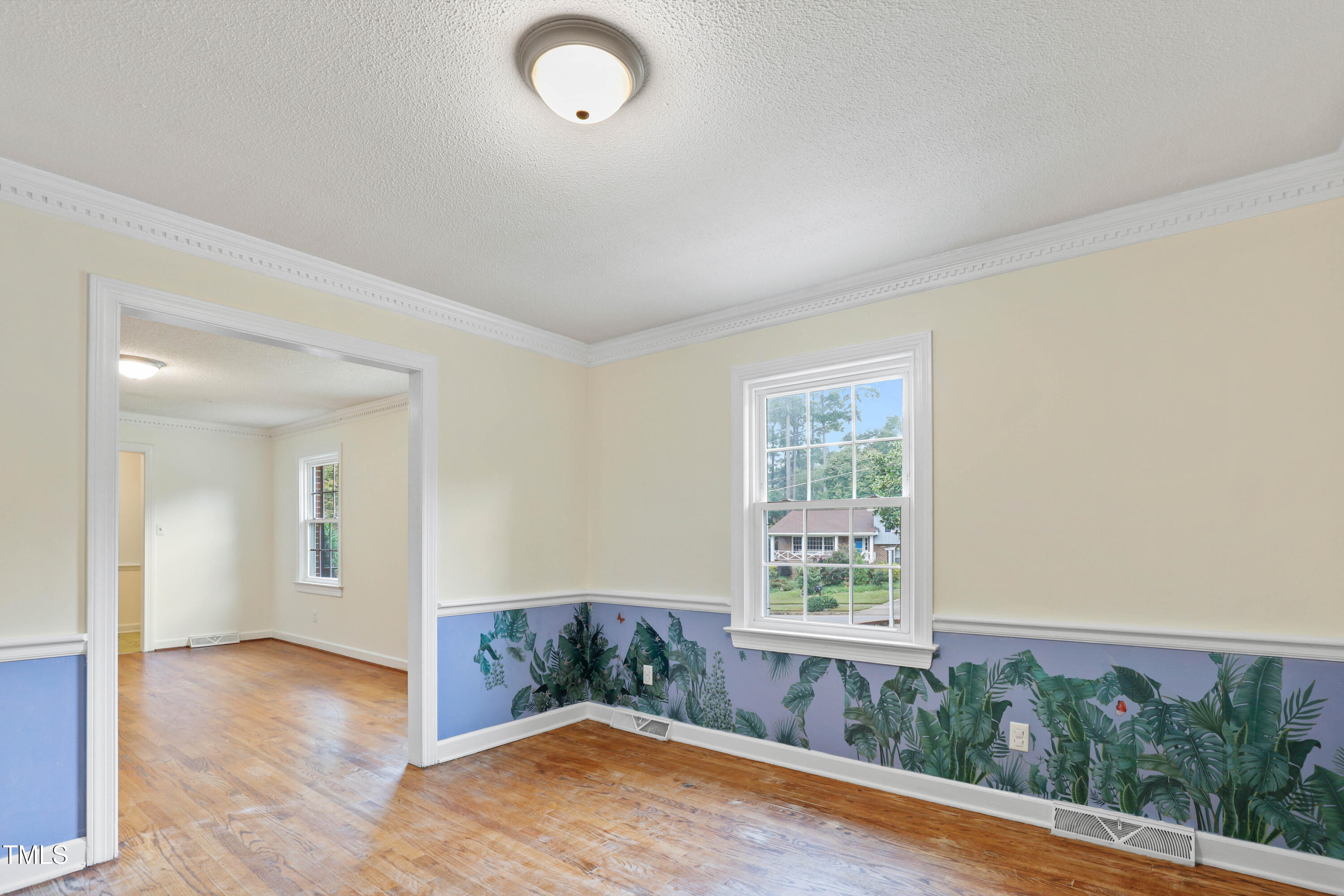 1204 Country Ridge Drive Raleigh, NC 27609 - Photo 19 of 49 an empty room with wooden floor and windows