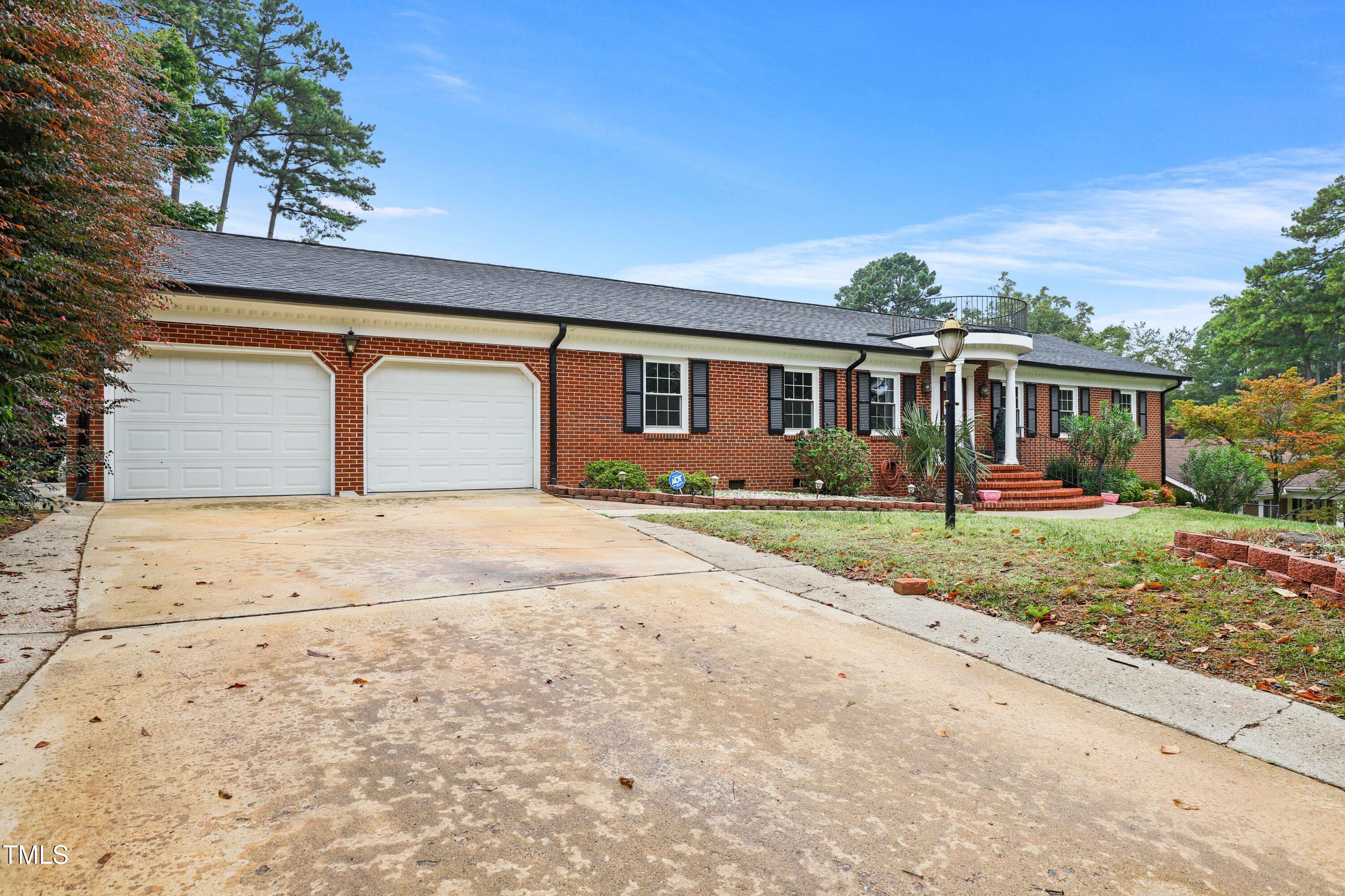 1204 Country Ridge Drive Raleigh, NC 27609 - Photo 2 of 49 front view of house next to a yard