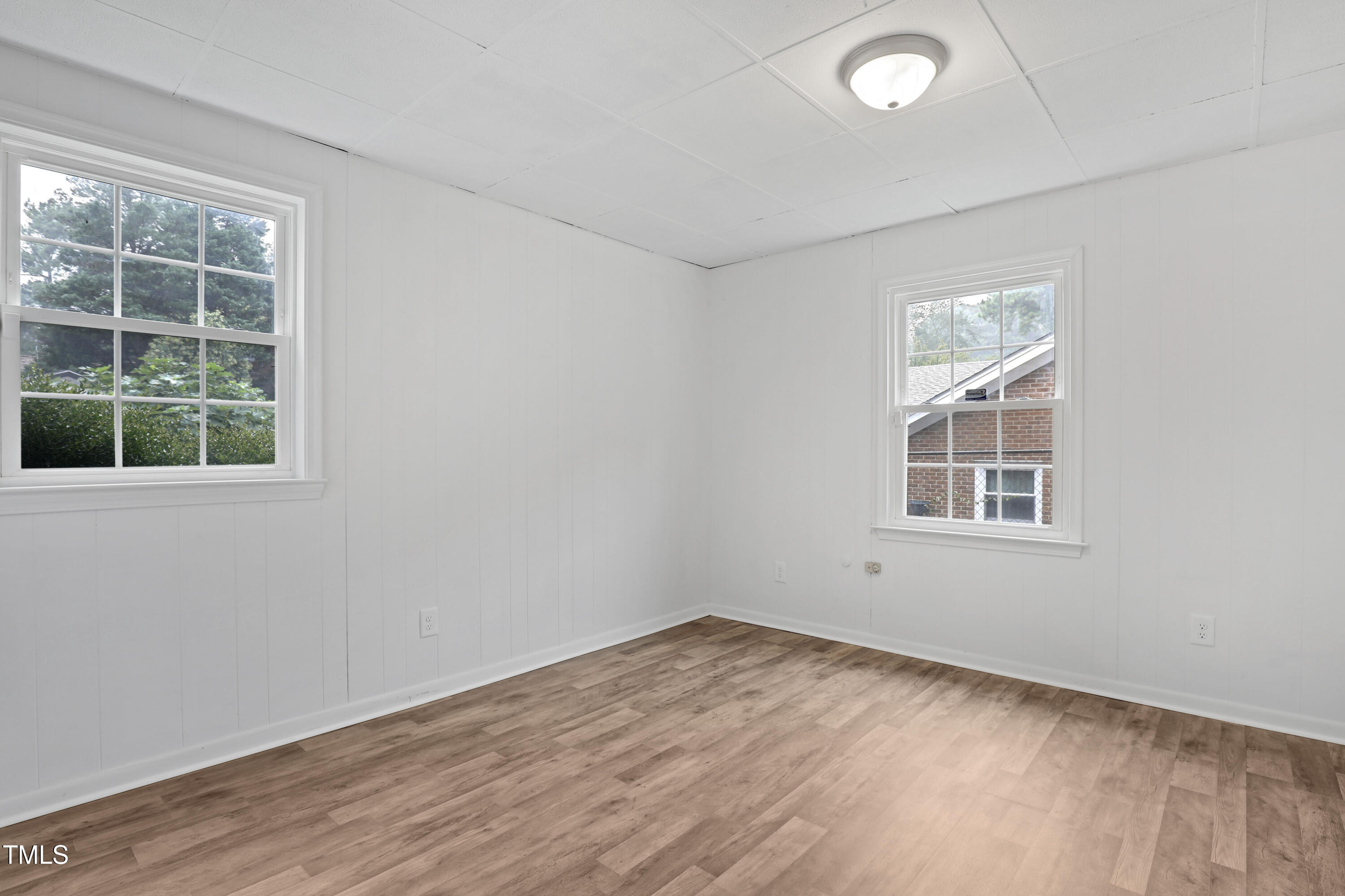 1204 Country Ridge Drive Raleigh, NC 27609 - Photo 23 of 49 an empty room with wooden floor and windows