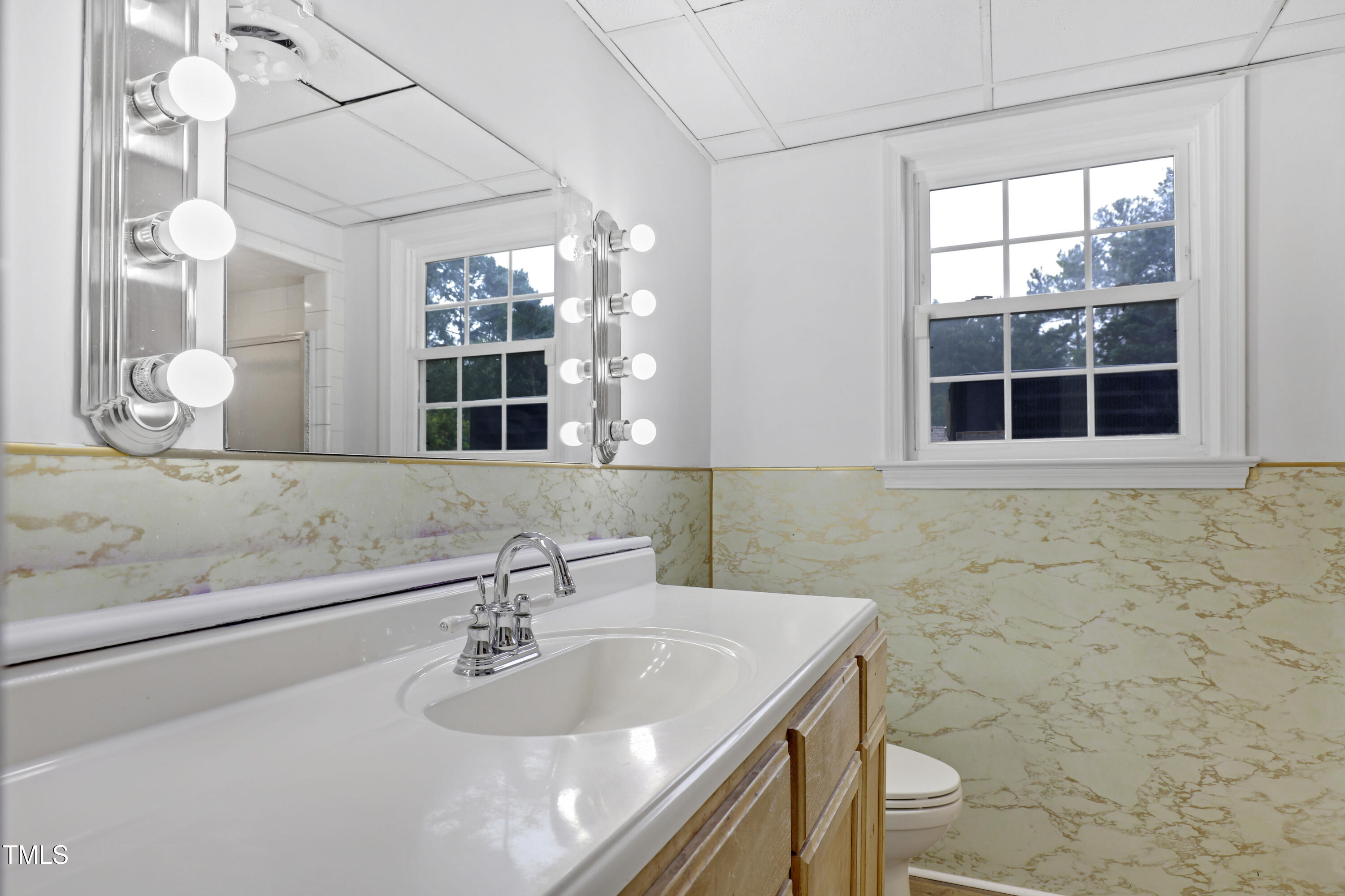 1204 Country Ridge Drive Raleigh, NC 27609 - Photo 25 of 49 a bathroom with a sink a toilet and a mirror
