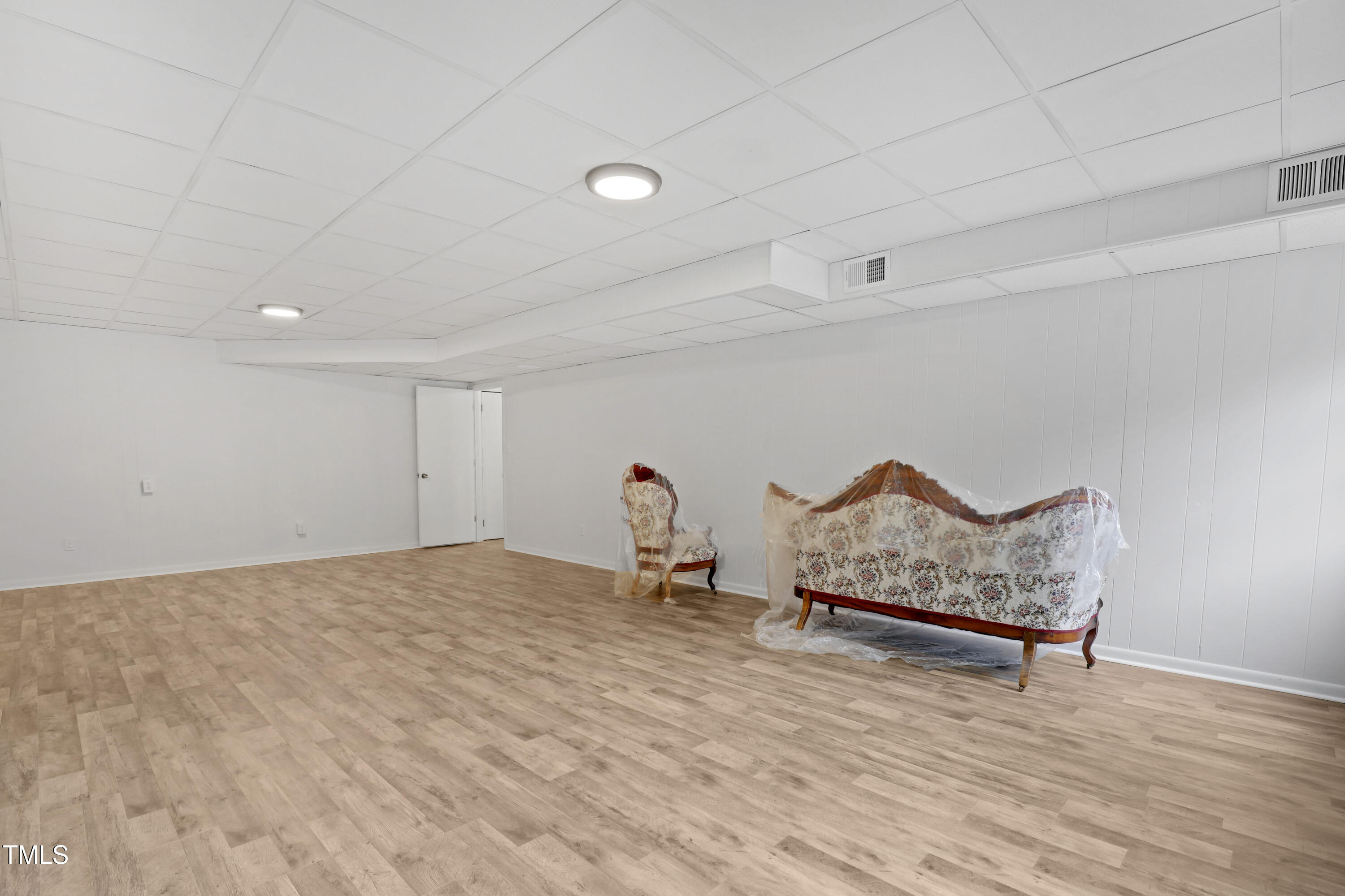 1204 Country Ridge Drive Raleigh, NC 27609 - Photo 28 of 49 a view of a room with wooden floor and a bench
